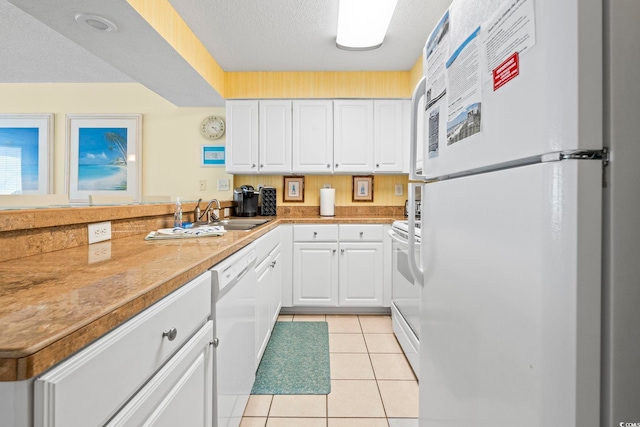5310 N Ocean Blvd Unit 7C, North Myrtle Beach, SC 29582 - kitchen featuring white appliances, white cabinets, light tile patterned floors, light countertops, and a textured ceiling