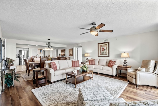 2151 Bridgeview Ct Unit 3-404, North Myrtle Beach, SC 29582 - living area with ceiling fan, wood finished floors, a textured ceiling, and a chandelier