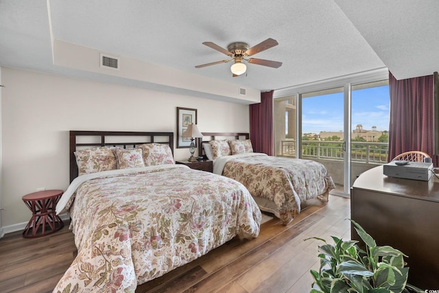 2151 Bridgeview Ct Unit 3-404, North Myrtle Beach, SC 29582 - bedroom with access to exterior, wood finished floors, ceiling fan, and a textured ceiling