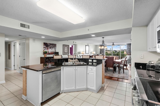 2151 Bridgeview Ct Unit 3-404, North Myrtle Beach, SC 29582 - kitchen with stainless steel appliances, dark countertops, a textured ceiling, open floor plan, and light tile patterned flooring