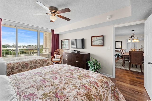 2151 Bridgeview Ct Unit 3-404, North Myrtle Beach, SC 29582 - bedroom with a textured ceiling, wood finished floors, a chandelier, access to exterior, and a ceiling fan