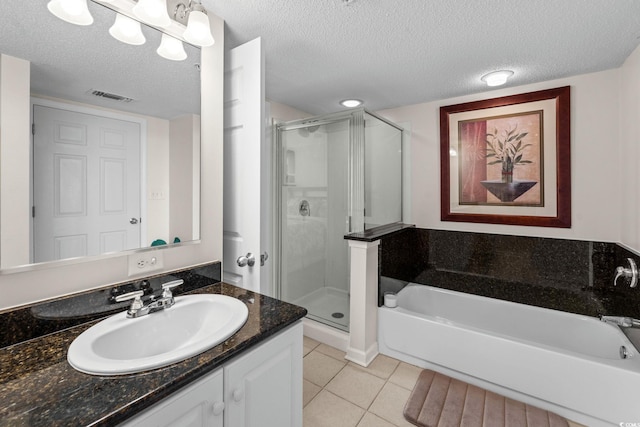2151 Bridgeview Ct Unit 3-404, North Myrtle Beach, SC 29582 - full bathroom with vanity, a shower stall, a bath, tile patterned floors, and a textured ceiling