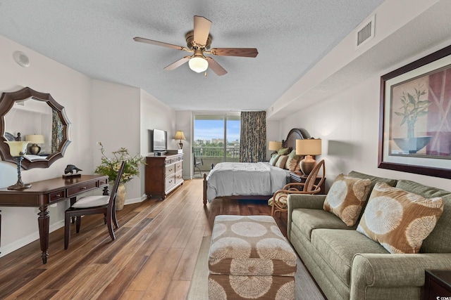 2151 Bridgeview Ct Unit 3-404, North Myrtle Beach, SC 29582 - bedroom with wood finished floors, access to exterior, a textured ceiling, and a ceiling fan