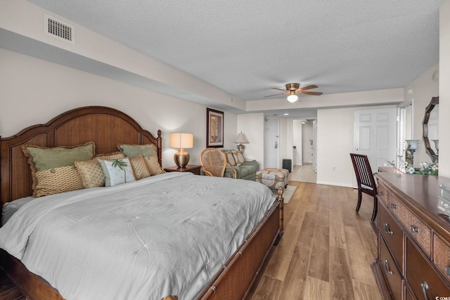 2151 Bridgeview Ct Unit 3-404, North Myrtle Beach, SC 29582 - bedroom with wood finished floors, a textured ceiling, and a ceiling fan