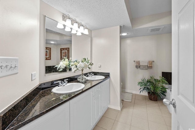 2151 Bridgeview Ct Unit 3-404, North Myrtle Beach, SC 29582 - full bathroom featuring double vanity, tile patterned flooring, and a textured ceiling