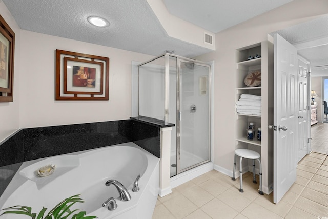 2151 Bridgeview Ct Unit 3-404, North Myrtle Beach, SC 29582 - bathroom featuring a stall shower, a garden tub, a textured ceiling, tile patterned flooring, and built in shelves
