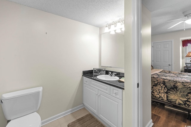 2151 Bridgeview Ct Unit 3-404, North Myrtle Beach, SC 29582 - bathroom with vanity, a textured ceiling, and a ceiling fan