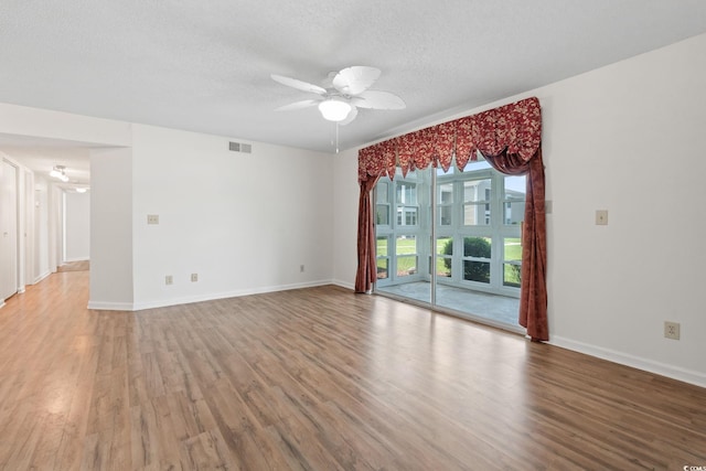 2122 Clearwater Dr Unit C, Surfside Beach, SC 29575 - spare room featuring wood finished floors, a ceiling fan, and a textured ceiling
