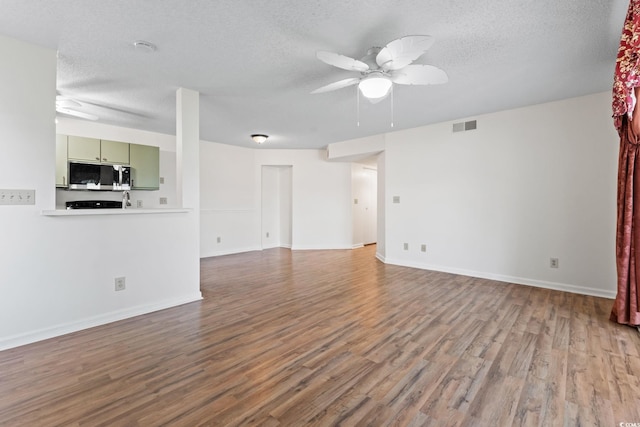 2122 Clearwater Dr Unit C, Surfside Beach, SC 29575 - unfurnished living room with ceiling fan, wood finished floors, and a textured ceiling