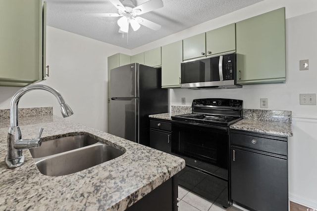 2122 Clearwater Dr Unit C, Surfside Beach, SC 29575 - kitchen featuring stainless steel microwave, black electric range oven, freestanding refrigerator, a ceiling fan, and green cabinetry