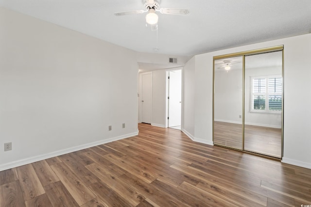 2122 Clearwater Dr Unit C, Surfside Beach, SC 29575 - unfurnished bedroom featuring wood finished floors, ceiling fan, and a closet