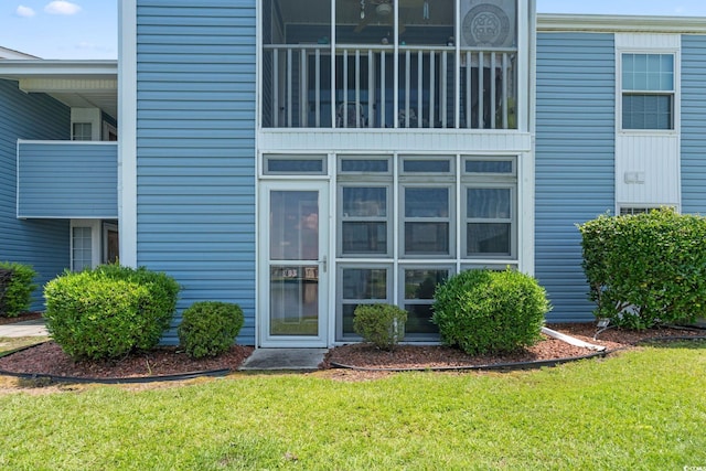 2122 Clearwater Dr Unit C, Surfside Beach, SC 29575 - view of exterior entry featuring a lawn