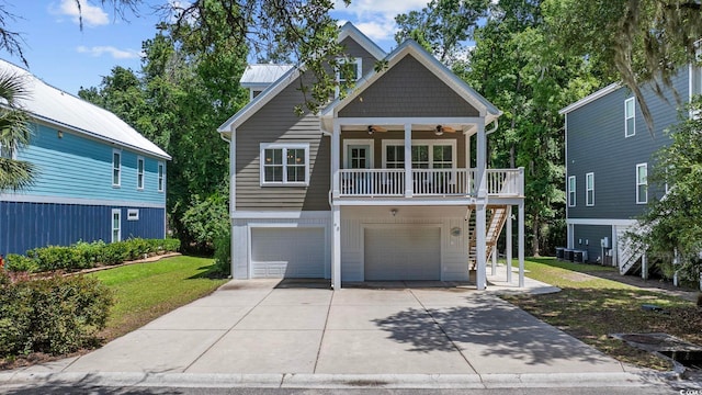 43 Sandlapper Way, Pawleys Island, SC 29585 - coastal home featuring ceiling fan, stairs, a front lawn, concrete driveway, and a garage