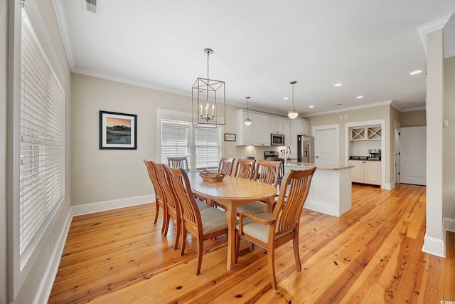 43 Sandlapper Way, Pawleys Island, SC 29585 - dining space featuring light wood-type flooring, recessed lighting, ornamental molding, and a chandelier