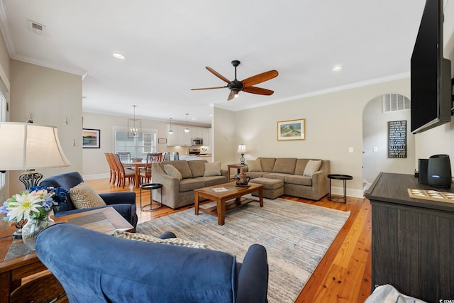 43 Sandlapper Way, Pawleys Island, SC 29585 - living room featuring a ceiling fan, arched walkways, light wood-style flooring, crown molding, and recessed lighting