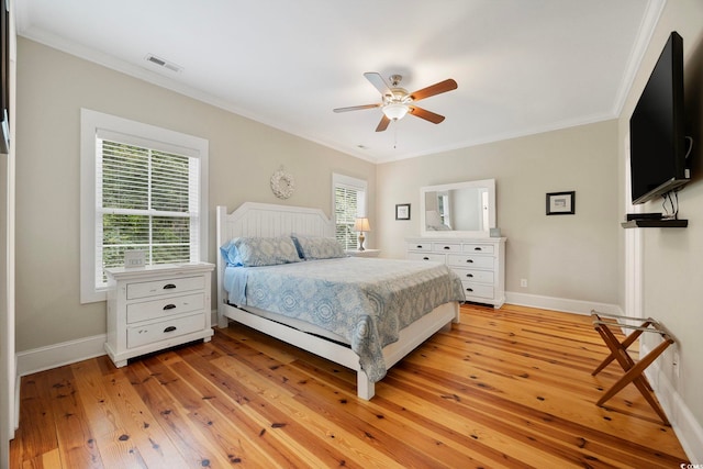 43 Sandlapper Way, Pawleys Island, SC 29585 - bedroom featuring multiple windows, crown molding, light wood-style flooring, and ceiling fan