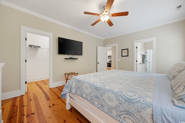 43 Sandlapper Way, Pawleys Island, SC 29585 - bedroom with crown molding, a walk in closet, light wood-style floors, and ceiling fan
