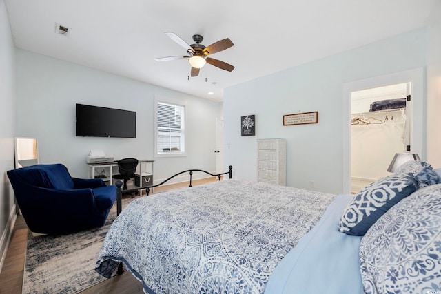 43 Sandlapper Way, Pawleys Island, SC 29585 - bedroom with wood finished floors, a spacious closet, and a ceiling fan