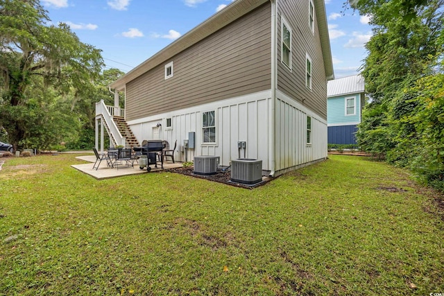43 Sandlapper Way, Pawleys Island, SC 29585 - rear view of property featuring board and batten siding, a patio, a lawn, and stairs