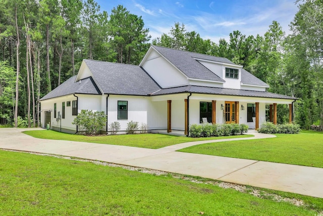 141 Evans Branch Ct, Galivants Ferry, SC 29544 - modern farmhouse with covered porch, a front lawn, a standing seam roof, and a shingled roof