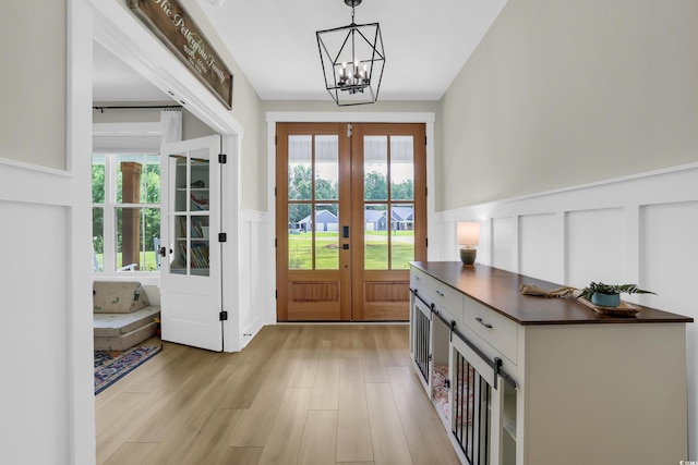 141 Evans Branch Ct, Galivants Ferry, SC 29544 - foyer featuring french doors, a decorative wall, wainscoting, healthy amount of natural light, and a chandelier