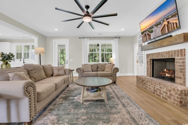 141 Evans Branch Ct, Galivants Ferry, SC 29544 - living area featuring wood finished floors, a ceiling fan, a fireplace, and recessed lighting