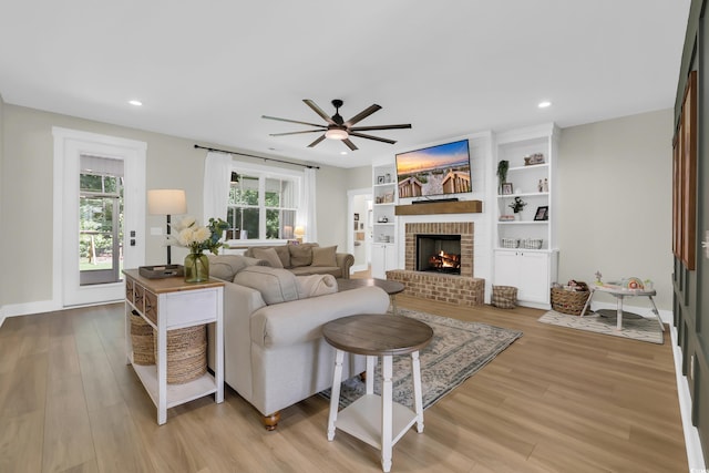 141 Evans Branch Ct, Galivants Ferry, SC 29544 - living area featuring a brick fireplace, light wood finished floors, a ceiling fan, and recessed lighting