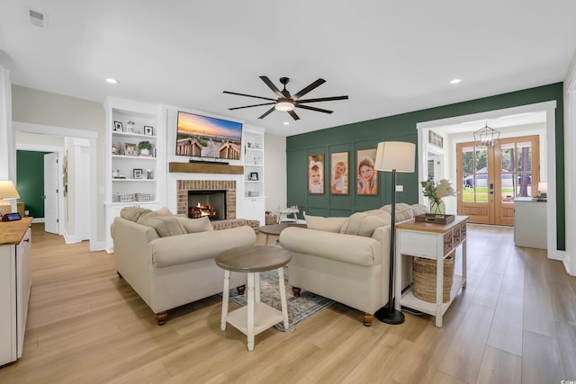 141 Evans Branch Ct, Galivants Ferry, SC 29544 - living area featuring a brick fireplace, light wood-type flooring, a ceiling fan, recessed lighting, and built in shelves
