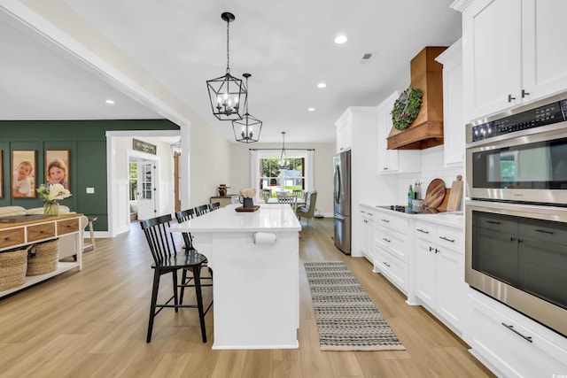 141 Evans Branch Ct, Galivants Ferry, SC 29544 - kitchen featuring appliances with stainless steel finishes, a chandelier, a breakfast bar area, a kitchen island, and light countertops