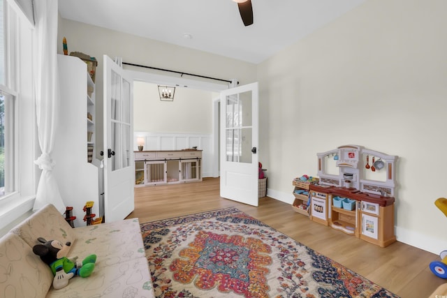 141 Evans Branch Ct, Galivants Ferry, SC 29544 - sitting room with wood finished floors, french doors, and ceiling fan