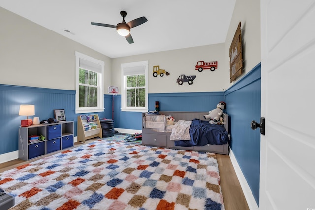 141 Evans Branch Ct, Galivants Ferry, SC 29544 - bedroom with wood finished floors, a wainscoted wall, and ceiling fan