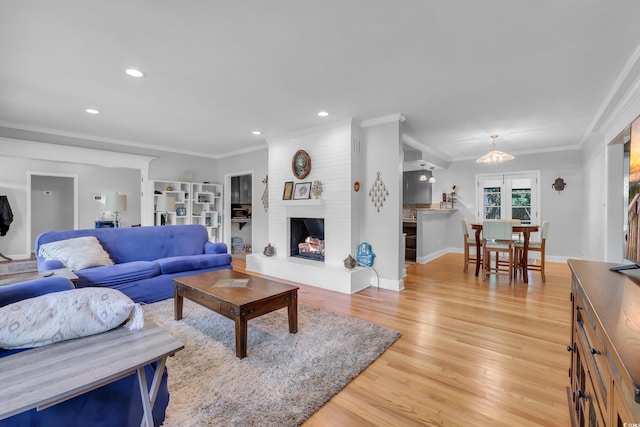 231 Live Oak Ln, Myrtle Beach, SC 29572 - living area featuring light wood-style flooring, recessed lighting, crown molding, and a brick fireplace