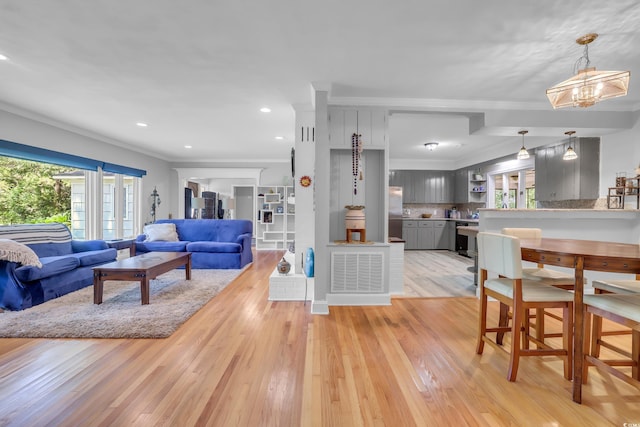 231 Live Oak Ln, Myrtle Beach, SC 29572 - living area featuring plenty of natural light, light wood-type flooring, recessed lighting, crown molding, and a chandelier