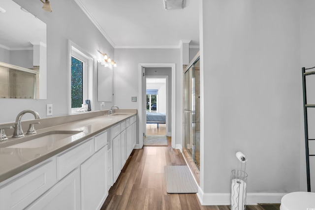 231 Live Oak Ln, Myrtle Beach, SC 29572 - bathroom with double vanity, wood finished floors, a shower with door, and ornamental molding