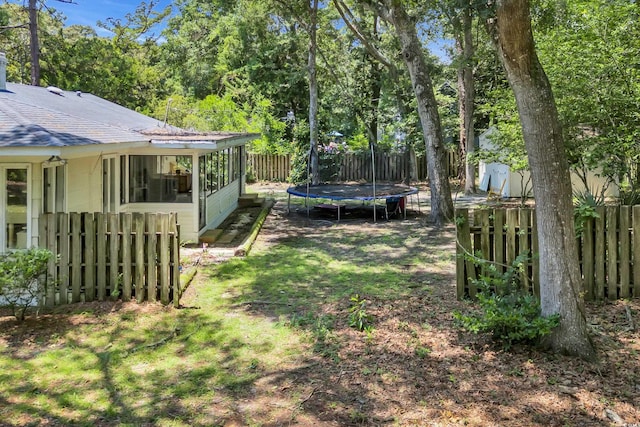 231 Live Oak Ln, Myrtle Beach, SC 29572 - fenced backyard with a trampoline and a sunroom