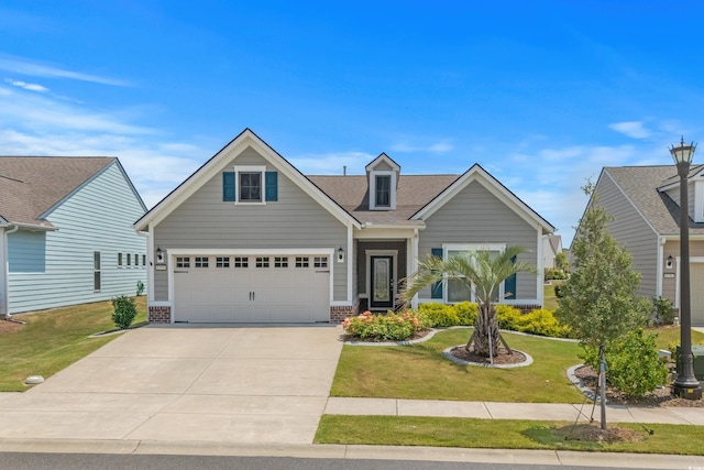 6550 Anterselva Dr, Myrtle Beach, SC 29572 - view of front of house with driveway, a front yard, brick siding, and a shingled roof