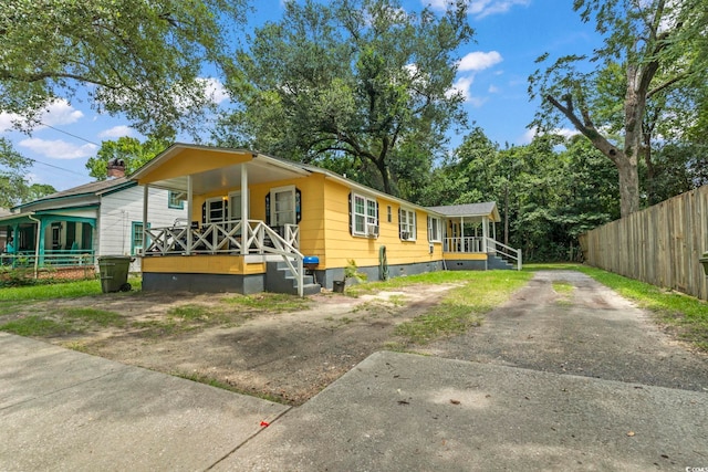414 King St, Georgetown, SC 29440 - view of front of house featuring covered porch, asphalt driveway, and crawl space