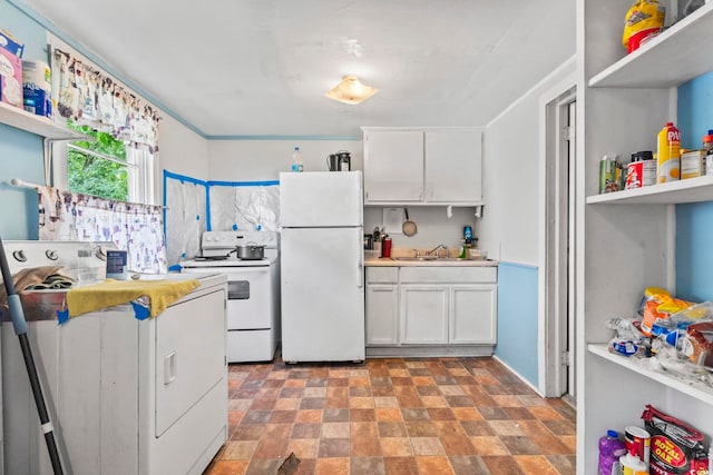 414 King St, Georgetown, SC 29440 - kitchen featuring white appliances, washer / clothes dryer, stone finish flooring, white cabinets, and light countertops