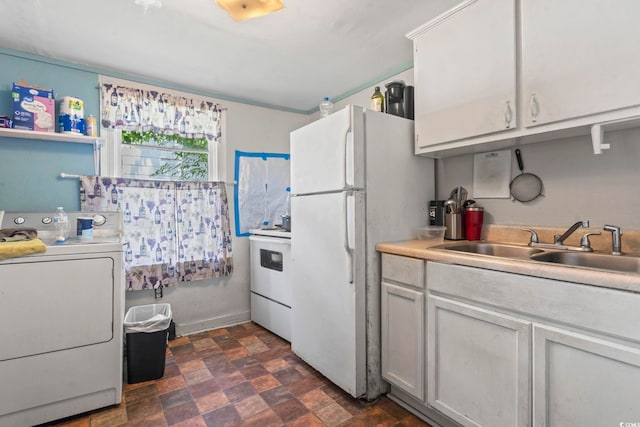 414 King St, Georgetown, SC 29440 - kitchen with washer / clothes dryer, freestanding refrigerator, stove, stone finish floors, and light countertops
