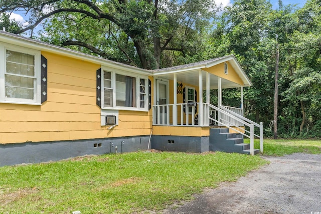 414 King St, Georgetown, SC 29440 - view of home's exterior featuring crawl space, covered porch, and a lawn