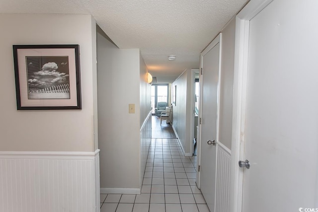 2101 S Ocean Blvd, North Myrtle Beach, SC 29582 - corridor with light tile patterned flooring and a textured ceiling