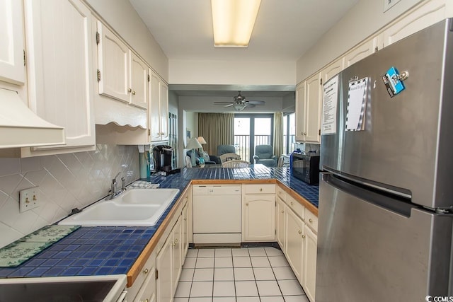 2101 S Ocean Blvd, North Myrtle Beach, SC 29582 - kitchen with freestanding refrigerator, dishwasher, a ceiling fan, tasteful backsplash, and light tile patterned floors
