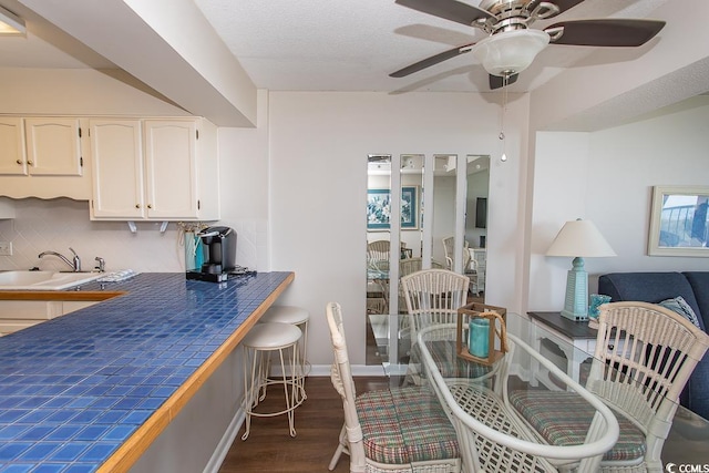 2101 S Ocean Blvd, North Myrtle Beach, SC 29582 - dining area with dark wood-style floors and a ceiling fan