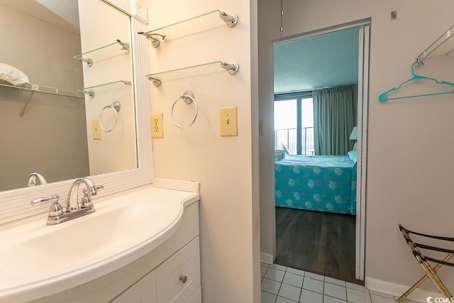 2101 S Ocean Blvd, North Myrtle Beach, SC 29582 - ensuite bathroom featuring vanity and tile patterned floors