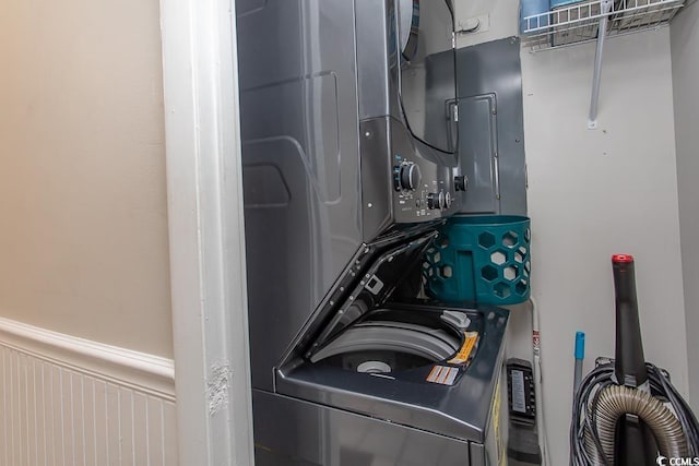2101 S Ocean Blvd, North Myrtle Beach, SC 29582 - laundry room featuring stacked washer / dryer and wainscoting