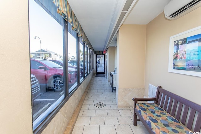 2101 S Ocean Blvd, North Myrtle Beach, SC 29582 - hall featuring a wall mounted air conditioner and light tile patterned floors