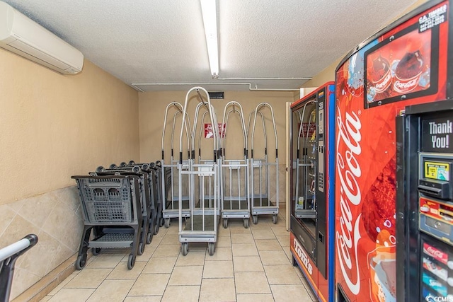 2101 S Ocean Blvd, North Myrtle Beach, SC 29582 - workout room featuring a wall mounted air conditioner, tile patterned flooring, and a textured ceiling
