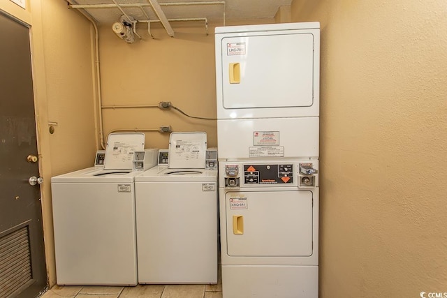 2101 S Ocean Blvd, North Myrtle Beach, SC 29582 - shared laundry room with stacked washer / dryer and light tile patterned flooring