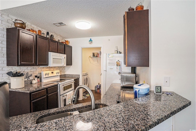 4925 Pond Shoals Ct Unit 202, Myrtle Beach, SC 29579 - kitchen with white appliances, dark brown cabinetry, dark stone counters, a textured ceiling, and tasteful backsplash