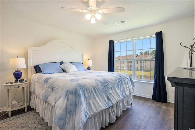 4925 Pond Shoals Ct Unit 202, Myrtle Beach, SC 29579 - bedroom featuring dark wood-type flooring, ceiling fan, and a textured ceiling